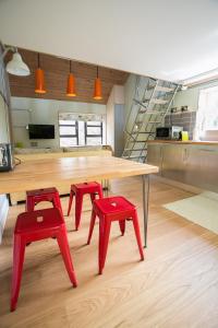 a table and two red stools in a kitchen at Claron Lodge in West Wittering