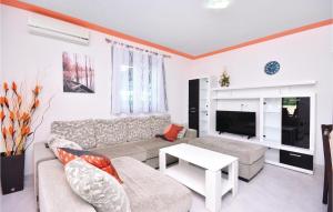 a living room with a couch and a tv at 3 Bedroom Nice Home In Solin in Split