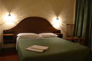 a bedroom with a bed with two towels on it at Hotel Al SanPietrino in Rome
