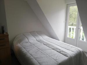 uma cama branca num quarto com uma janela em T3, 30 mn de PEYRAGUDES, ST LARY, VAL LOURON (65) : 04 personnes em Hèches