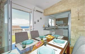 a dining room with a table and a view of the ocean at Beautiful Apartment In Makarska With House Sea View in Makarska