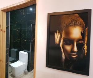 a painting of a woman on the wall of a bathroom at Apartamenty PRETTY WOMAN self check-in 24h - Bytom Chorzów Katowice in Bytom +84 photos