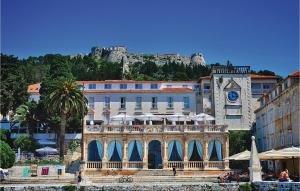 a building with a clock tower in front of a building at Nice Home In Hvar With 3 Bedrooms And Internet in Hvar