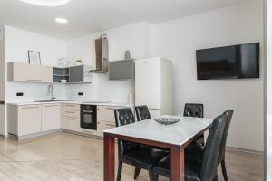 a kitchen and dining room with a table and chairs at At Home Apartment in Odesa