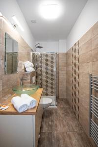 a bathroom with a sink and a shower at City Panzió in Szarvas