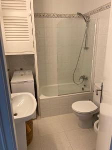 a bathroom with a toilet and a tub and a sink at HOLIDAYS MENORCA Cala Galdana in Cala Galdana