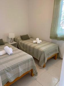 2 camas individuales en una habitación con ventana en HOLIDAYS MENORCA Cala Galdana, en Cala Galdana