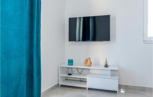 a white table with a television on a wall at Cozy Apartment In Srima in Srima