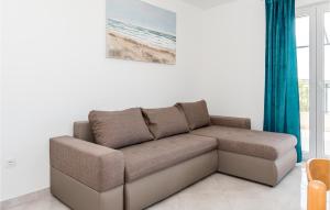 a brown couch in a living room with blue curtains at Cozy Apartment In Srima in Srima +15 photos
