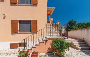a building with a staircase in front of a house at Apartment Gajana Croatia in Gajana