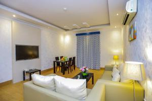 a living room with a couch and a dining room at Hospitality Path Serviced Apartments in Riyadh