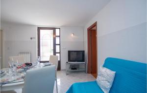 a living room with a table and a couch at Amazing Apartment In Labin With Kitchen in Labin