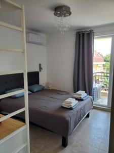 A bed or beds in a room at Obzor Tatyana Apartments The Wave