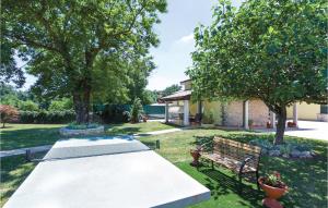a picnic table and a bench in a yard at Holiday Home Badnjevari Vi in Benčići
