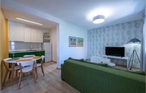 a living room with a couch and a table and a kitchen at Cozy Apartment In Ravni With Kitchen in Ravni