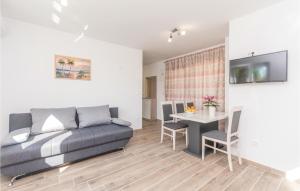 a living room with a couch and a table at Awesome Apartment In Biograd Na Moru With Kitchen in Biograd na Moru