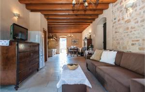a living room with a couch and a tv at 2 Bedroom Pet Friendly Home In Postira in Postira