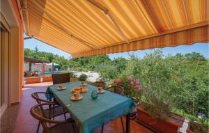 a table with a blue table cloth on a patio at 3 Bedroom Awesome Home In Labin in Labin