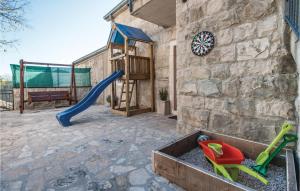 a playground with a slide and a play equipment at Amazing Home In Podstrana With House Sea View in Podstrana