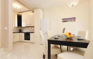 a kitchen and dining room with a table and chairs at Lovely Home In Zadar With Wifi in Zadar