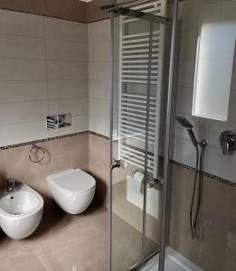 a bathroom with a shower and a toilet and a sink at L'ANGELICA AFFITTACAMERE in Grottaminarda