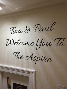 a sign on a wall that reads time and paid welcome to the attic at The Aspire in Blackpool