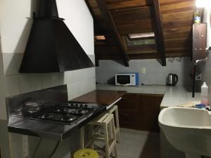 a kitchen with a stove and a sink at Zorzal 2 in Puerto Rico