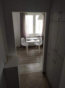a room with a table and chairs and a window at Apartament Centrum in Koszalin