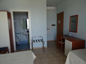 a room with a bathroom with a sink and a toilet at Hotel Sole E Mare in Lido di Camaiore