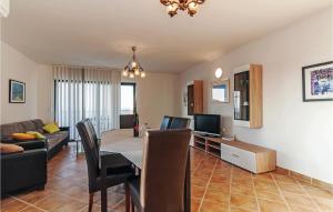 a living room with a table and a dining room at Gorgeous Apartment In Privlaka With Wifi in Privlaka
