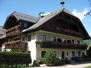 a house with flower boxes on the balconies at Hoferbauergut in Strobl