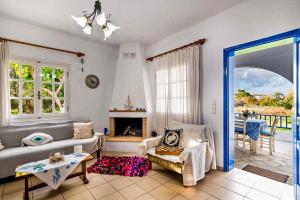 a living room with a couch and a fireplace at Blue Beach House in Kissamos
