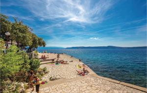 a group of people on a beach near the water at 2 Bedroom Awesome Apartment In Selce in Selce