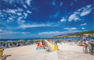 a beach with a lot of people on it at 2 Bedroom Awesome Apartment In Selce in Selce +17 photos