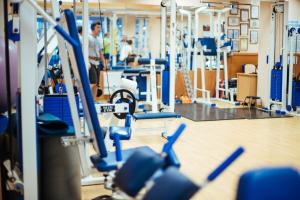 a gym with blue chairs and people in the background at Hotel Bristol in Yalta