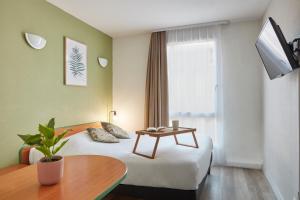 Voodi või voodid majutusasutuse Aparthotel Adagio Access Bordeaux Rodesse toas