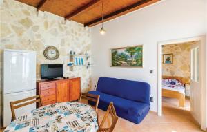 a living room with a blue couch and a bedroom at Stunning Home In Slano With 1 Bedrooms And Wifi in Slano