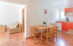 a kitchen and dining room with a table and chairs at Beautiful Apartment In Krvavica With Wifi in Krvavica