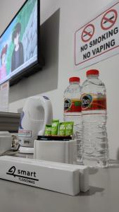 two bottles of water on a counter in a store at Smart Tlogomas Syariah in Malang