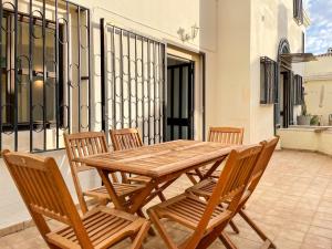 a wooden table and chairs on a patio at T1 center of Marina Vilamoura in Quarteira