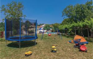 a playground with play equipment in the grass at Cozy Home In Ruzici With Kitchen in Ružići
