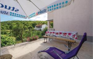 a patio with a table and chairs on a balcony at Stunning Apartment In Brsec in Brseč