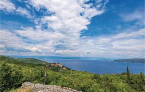 a view of a large body of water on a hill at Stunning Apartment In Brsec in Brseč