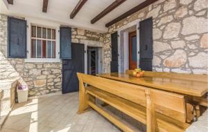 a wooden bench sitting in front of a stone wall at Two-Bedroom Apartment In Vrsar in Vrsar +21 photos