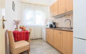 a kitchen with a table with a red table cloth at Stunning Apartment In Vir With 5 Bedrooms And Wifi in Vir