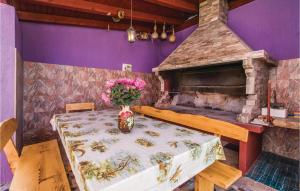 a table with a vase of flowers on a table with a stone fireplace at Awesome Apartment In Fazana With 3 Bedrooms And Wifi in Fažana