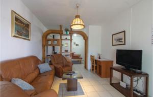 a living room with a couch and a television at Awesome Apartment In Racisce With Kitchenette in Račišće