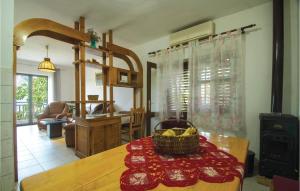 a kitchen with a table with a basket of fruit on it at Awesome Apartment In Racisce With Kitchenette in Račišće
