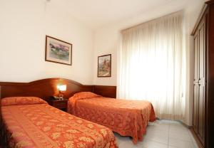 Letto o letti in una camera di Hotel Pavone