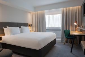 A bed or beds in a room at Holiday Inn Bolton Centre, an IHG Hotel